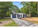 Quaint one-story home with fresh paint and manicured lawn, situated in a quiet neighborhood at 6932 Eunice Dr, Riverdale, GA 30274