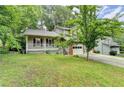 Charming two-story home featuring a covered porch and a traditional brick and siding exterior at 2121 Crescentview Dr, Lawrenceville, GA 30044