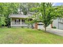 Charming two-story home featuring a covered porch and a traditional brick and siding exterior at 2121 Crescentview Dr, Lawrenceville, GA 30044