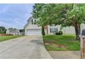 Inviting two-story home with a well-maintained lawn and a long driveway leading to the garage at 2355 Glen Chase Ln, Lawrenceville, GA 30044