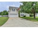 Charming two-story home with a two-car garage, manicured lawn, and mature landscaping at 2355 Glen Chase Ln, Lawrenceville, GA 30044