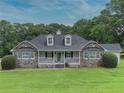 Inviting home with stone siding, dormer windows, and a charming front porch at 2759 Bay Ridge Dr, Loganville, GA 30052