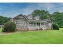 Beautiful home with stone accents, a covered front porch, and lush green lawn at 2759 Bay Ridge Dr, Loganville, GA 30052