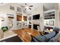 Bright living room with a fireplace, built-in shelves, and hardwood floors at 2797 Middlecreek Way, Cumming, GA 30041