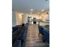 Spacious open-concept living room and kitchen with stainless steel appliances and modern finishes at 3558 Eagle Court, Fulton, GA 30331