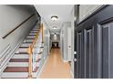 Bright foyer with staircase leading to the upper level and views of the living area at 4971 Jenny Dr, Acworth, GA 30101