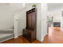 Warm entryway featuring hardwood floors, stairs, coat rack, and access to the main living area at 6901 Gallant Se Cir # 13, Mableton, GA 30126