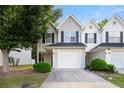 Charming townhome featuring a one-car garage, manicured landscaping, and neutral siding for a welcoming curb appeal at 6901 Gallant Se Cir # 13, Mableton, GA 30126