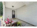Inviting front porch with potted plants leading to a charming front door and light grey exterior at 6901 Gallant Se Cir # 13, Mableton, GA 30126