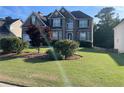 Charming two-story home with landscaped yard and brick and stone exterior, perfect for curb appeal at 582 Georgia Cir, Loganville, GA 30052