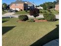 Well maintained lawn with healthy trees, shrubbery and mulch at 582 Georgia Cir, Loganville, GA 30052