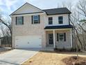 Charming two-story home featuring a two-car garage, light brick facade, and stylish black shutters at 18 Loth Wages (Lot 18) Rd, Dacula, GA 30019
