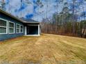Backyard view showcasing the covered patio, offering serene outdoor living space at 5295 Greenway Dr, Villa Rica, GA 30180
