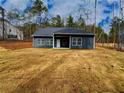 Rear exterior view of the house, highlighting its spacious backyard and peaceful setting at 5295 Greenway Dr, Villa Rica, GA 30180