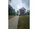 Charming two-story home with a large front yard, two porches, and an attached garage at 1228 Ladd Sw St, Atlanta, GA 30310