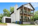 Two-story home featuring double front porches, an oversized chimney, and a two car garage at 1228 Ladd Sw St, Atlanta, GA 30310