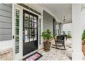 Inviting front porch with rocking chairs and a decorative door, perfect for relaxing and enjoying the outdoors at 1974 Hosack Sw Hl, Marietta, GA 30064