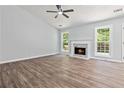 Bright living room features a fireplace, ample natural light, and wood-look flooring at 231 Clarion Rd, Lawrenceville, GA 30043
