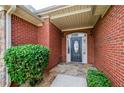 Stylish front entrance featuring a brick facade, stone pathway and manicured landscaping at 9157 Golfview Cir, Covington, GA 30014
