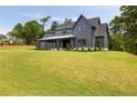 Charming two-story gray home with a large, well-manicured lawn and modern farmhouse appeal at 157 Palisade Ne Dr, Rydal, GA 30171