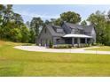 Beautiful two-story gray home featuring a two-car garage and a meticulously landscaped front yard at 157 Palisade Ne Dr, Rydal, GA 30171