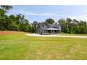 Attractive two-story gray home with an attached garage and spacious front yard at 157 Palisade Ne Dr, Rydal, GA 30171