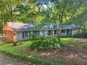Charming single-story home with painted brick, well-maintained landscaping, and a covered carport at 161 E 78 Hwy, Temple, GA 30179