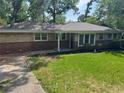Charming brick home with manicured lawn and driveway at 2903 Santa Barbara Dr, Decatur, GA 30032