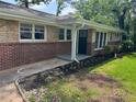 Home showcasing a front door and brick exterior with a manicured lawn at 2903 Santa Barbara Dr, Decatur, GA 30032