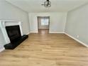 Bright living room featuring a fireplace, ceiling fan and light wood flooring at 5464 Fox Haven Trl, Stone Mountain, GA 30088