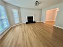 Living room with large windows providing light, complemented by a classic fireplace at 5464 Fox Haven Trl, Stone Mountain, GA 30088