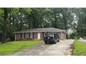 Traditional brick ranch-style home with lush green lawn and long driveway at 679 Winchester Ln, Norcross, GA 30071