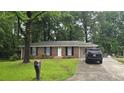 Cozy home with a charming brick facade and a well-kept lawn at 679 Winchester Ln, Norcross, GA 30071