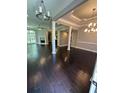 Open concept living room with hardwood floors, fireplace, and natural light at 1305 Lake Forest Ln, Mcdonough, GA 30253