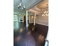 Bright living room featuring dark wood floors, decorative columns, and a fireplace at 1305 Lake Forest Ln, Mcdonough, GA 30253