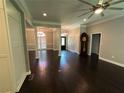 Open-concept living area with hardwood floors, decorative columns, and a ceiling fan at 1305 Lake Forest Ln, Mcdonough, GA 30253