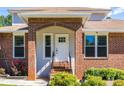 Inviting front porch with brick columns and steps leading to a white front door at 1480 Shady Cove Ln, Lawrenceville, GA 30043