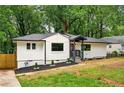 Charming home with manicured front yard, fresh white paint, and a welcoming entryway at 1599 Sandtown Rd, Atlanta, GA 30311