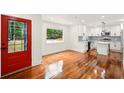 Open floor plan showcasing the stylish kitchen with stainless appliances and a bright red door at 1599 Sandtown Rd, Atlanta, GA 30311
