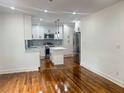 Open-concept kitchen with white cabinetry, stainless steel appliances, and a modern island at 1599 Sandtown Rd, Atlanta, GA 30311