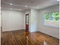 Spacious living room with hardwood floors, freshly painted white walls, with natural light at 1599 Sandtown Rd, Atlanta, GA 30311