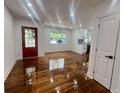 Bright living room with hardwood floors, freshly painted white walls, and a view of the front yard at 1599 Sandtown Rd, Atlanta, GA 30311