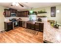 Modern kitchen featuring stainless steel appliances, dark cabinetry, and unique backsplash and countertops at 689 Hardin Rd, Temple, GA 30179