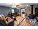Comfortable living room featuring a wood-burning stove, wood flooring, and a neutral color palette at 689 Hardin Rd, Temple, GA 30179
