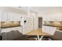 Modern kitchen with stainless steel appliances, granite countertops, and ample cabinet space at 2561 Grapevine Cir # 104, Cumming, GA 30041