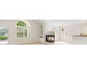 Bright living room with a fireplace, large windows, and an open floor plan at 2561 Grapevine Cir # 104, Cumming, GA 30041