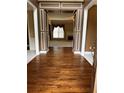 Elegant foyer featuring gleaming hardwood floors, decorative molding, and an open view to the living area at 3360 Keenland Rd, Marietta, GA 30062