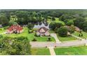 Aerial view of a beautiful home with a large lawn and pond at 127 Courts Of Hampton, Hampton, GA 30228