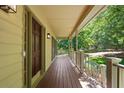 Close-up of the porch showcasing the wood flooring and view of the green lawn at 2120 Habersham Trce, Cumming, GA 30041