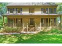 Inviting front porch with wooden railings, steps, and a well-maintained lawn at 2120 Habersham Trce, Cumming, GA 30041